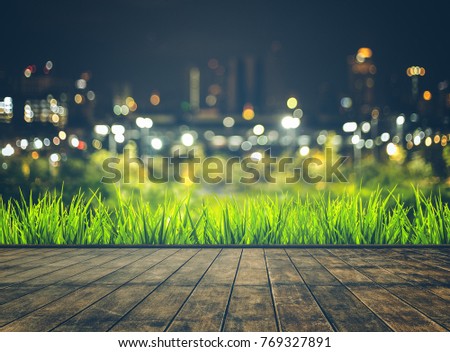 wooden table blurred sky night city building