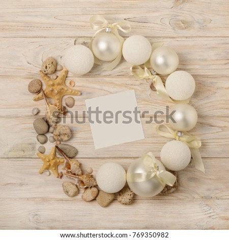 Christmas and New Year. Christmas wreath of Christmas-tree white toys in marine style, shells, stones and starfish. Selective focus.