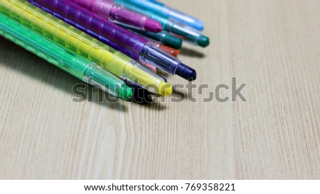 Multicolored pencils isolated on wood background. Colorful row curve of colored pencils, Color Pencils, back to school. 