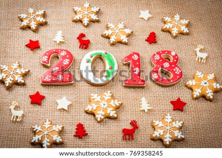Christmas gingerbread cookies snowflakes and 2018 on burlap background with copy space. Holiday, celebration and cooking concept. Merry Christmas postcard