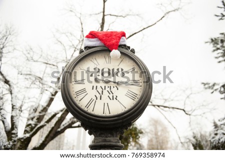 vintage street clock with title Happy New Year 2018 and Santa Claus hat on them