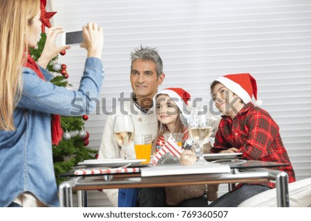 Mother making picture to the rest of family at home for Christmas.