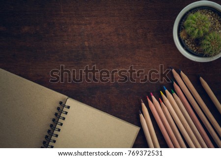 Note book with Color pencils on wood table, Top view