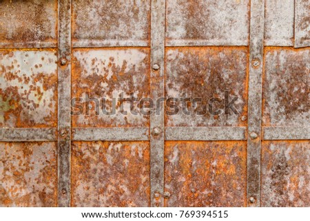 Detail of old metal doors reinforced with steel bands. Weathered cross steel  metallic texture elements of the old door. Antique Background