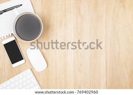 Top view of wooden office desktop with empty smartphone screen, supplies and other objects. Mock up. Technology and computer concept 