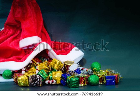 present gift boxes stack on ground with dark green blue background near red white cloth