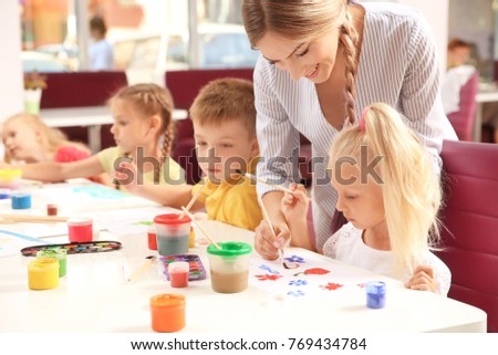 Children at painting lesson in classroom