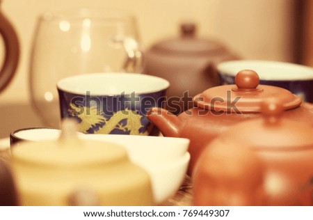 tea in kettles and cups is on the table