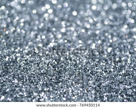 Silver sparkling glitter bokeh background.