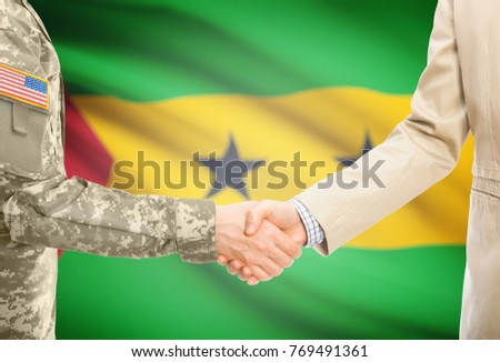 American soldier in uniform and civil man in suit shaking hands with adequate national flag on background - Sao Tome and Principe
