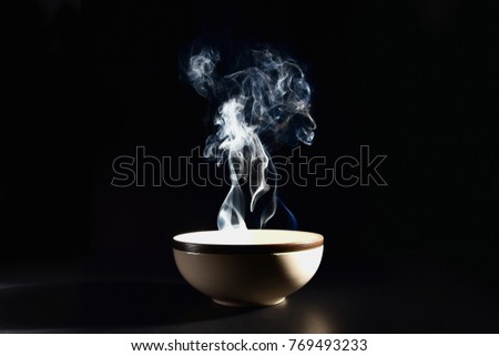 Picture of smoke rising from the food above the cup The concept of hot food.