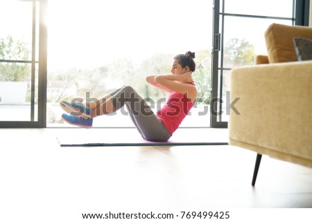 Woman doing fitness exercises at home