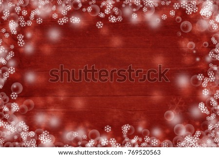 Christmas background with wooden boards, falling snow and snowy stars on a red background