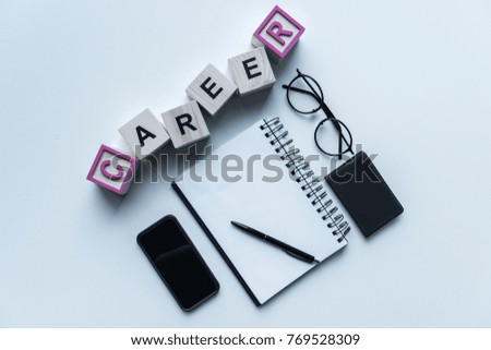 top view of wooden cubes with word Career and notebook with pen on table