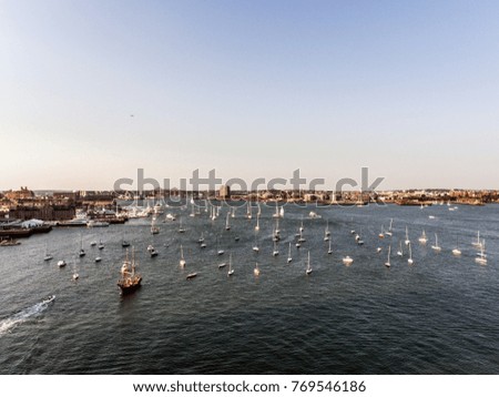 helicopter flight Aerial view image Boston MA, USA during sunset harbor with boats near waterfront bay