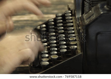 Fingers printed on old writing machine. Moved picture of the hands over the typing keyboard.