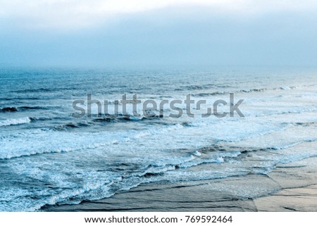 The ocean at sunrise in foggy weather
