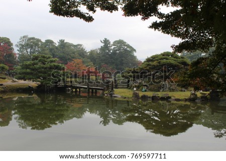 Wooden bridge and fall colors in Genkyu-en Garden near Hikone Castle, Hikone, Japan