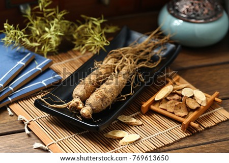 ginseng in black plate on wooden table