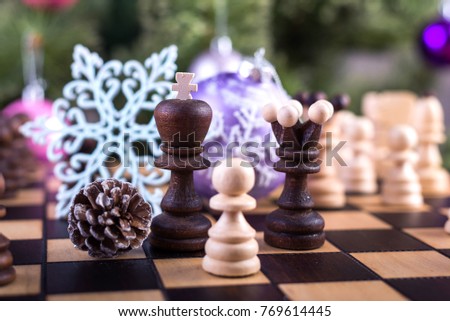 Christmas wooden chess. Christmas tree and chess board with figures.