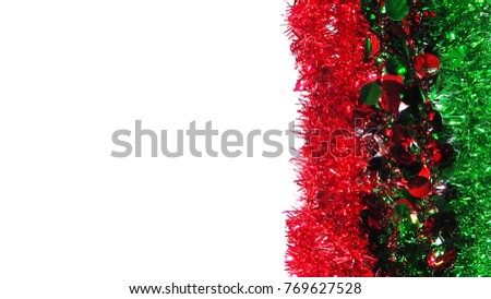 Red and green festive decorations tassels are arranged on the right side of the picture on a white background, the left side of the picture has a blank space to put text.