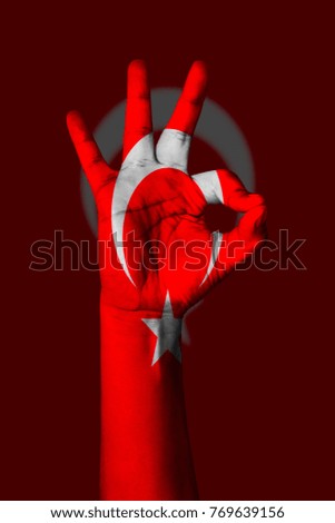Hand making Ok sign, Tunisia flag painted as symbol of best quality, positivity and success - isolated on flag background