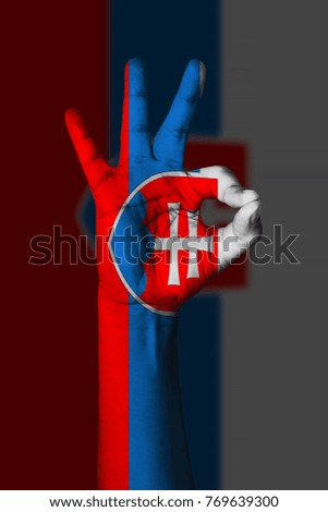 Hand making Ok sign, Slovakia flag painted as symbol of best quality, positivity and success - isolated on flag background