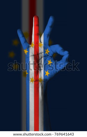 Hand making Ok sign, Cape verde flag painted as symbol of best quality, positivity and success - isolated on flag background