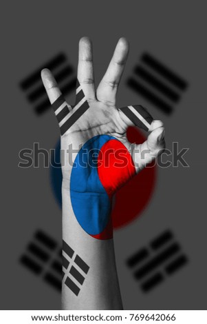 Hand making Ok sign, korea south flag painted as symbol of best quality, positivity and success - isolated on flag background