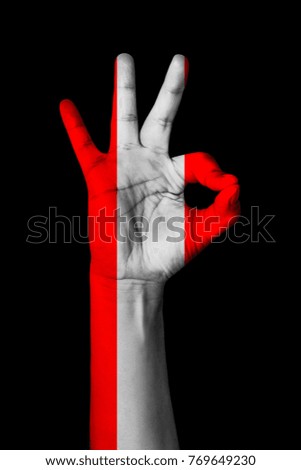 Hand making Ok sign, Austria flag painted as symbol of best quality, positivity and success - isolated on black background