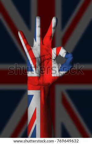 Hand making Ok sign, Anguilla flag painted as symbol of best quality, positivity and success - isolated on flag background