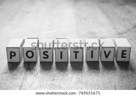 concept word forming with cube on wooden desk background - Positive