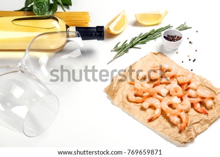 Composition with wine and ingredients for shrimp pasta on white background