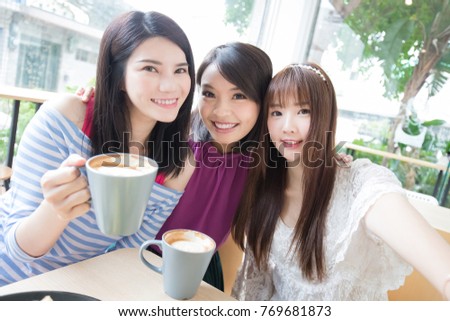 woman friends smile and selfie in restaurant