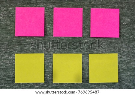 Collection of different colored sheets of note papers empty colorful on the board dark tone style background content for use writer of media articles writers publishers print media blogs websites