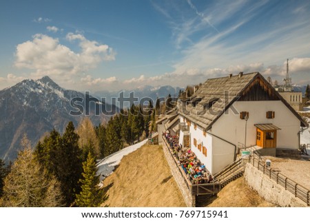 open air cafe with majestic panoramic view of mountains in small ancient village in Monte Lussary, Tarvisio, Friuli-Venezia Giulia, Italy
