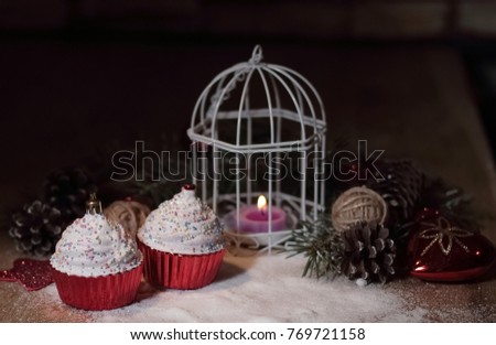 cupcakes,Christmas candle and Christmas decorations on wooden ba