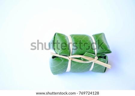 Sweet snack wrapped in banana leaves