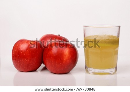 Red apples and a glass of fresh  juice isolated on white background
