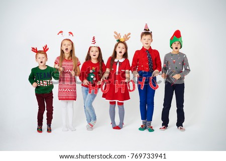 Happy children singing christmassy carols 