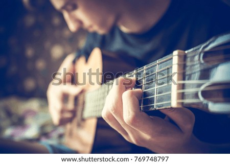 musician playing acoustic guitar, live music background