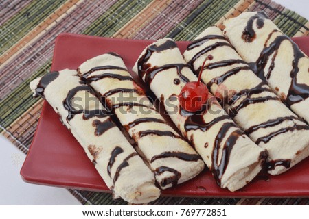 bread rolls chocolate milk sauce on red plate