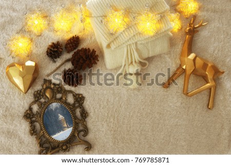 Winter concept with cozy lifestyle objects over fur carpet. Top view