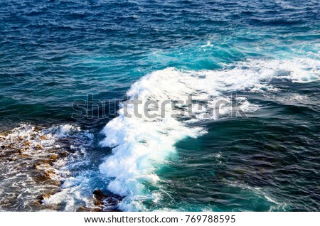 Ocean water and wave in tropical beach background.