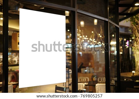 Blank promotion poster display on glass window at restaurant or cafe,promotion information for announcement message successful marketing