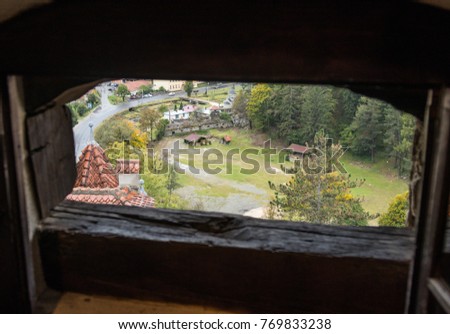 View of the old Bran city through the slaughterhouse in the watchtower of Bran Castle. Bran city in Romania