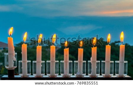 Menorah with glitter lights of candles is traditional symbol for Jewish Hanukkah Holiday
