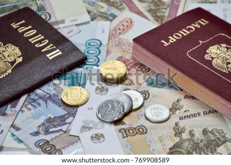 russian passport and few coins on banknotes background