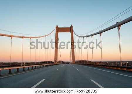 A bridge between Denmark and Sweden early in an autumn morning. A Danish-Swedish detective series of the same name is connected with this bridge. The picture is taken in direction of Denmark.