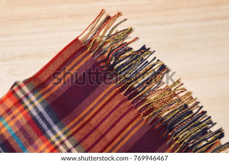 Scarf texture isolated on wooden background
